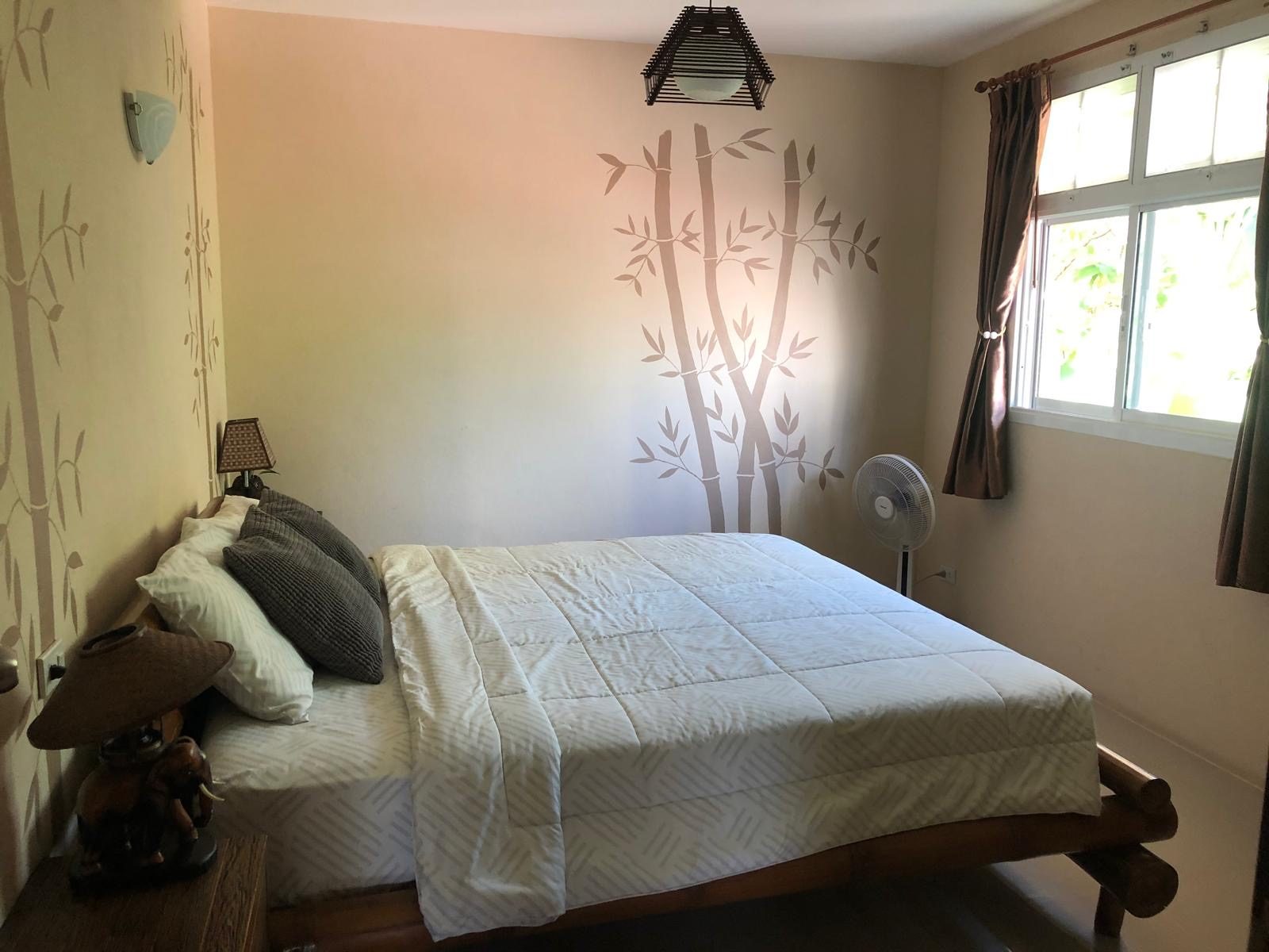 Upper floor first bedroom with white bedding